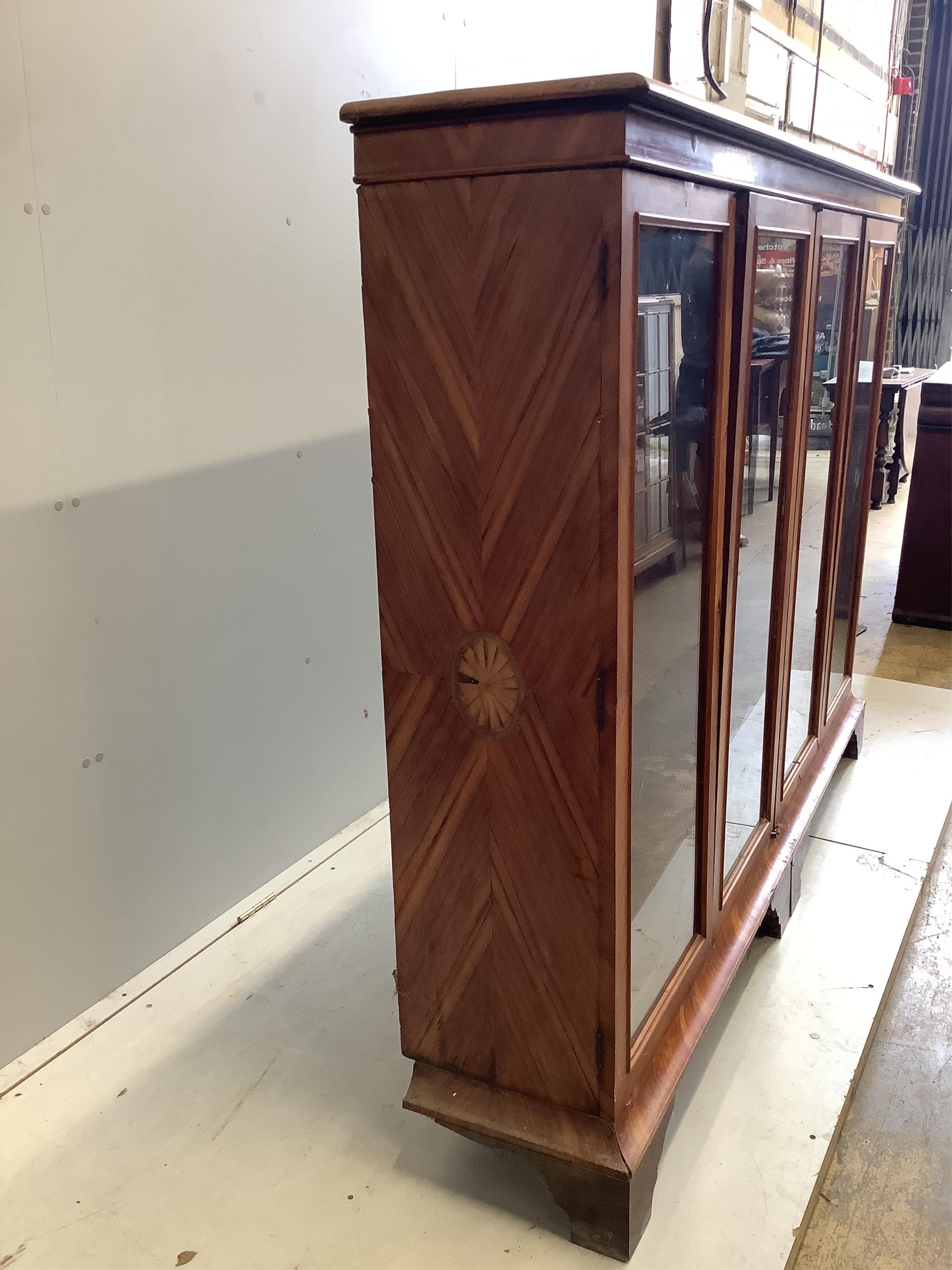 A large 19th century glazed kingwood bookcase, fitted four hinged doors and three adjustable shelves, width 190cm, depth 36cm, height 145cm. Condition - poor